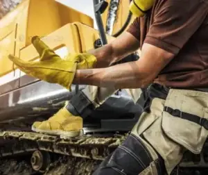 Laudo de Gancho de Moitão de Guindaste 4 Trabalhador com equipamentos de proteção manuseando ferramentas.