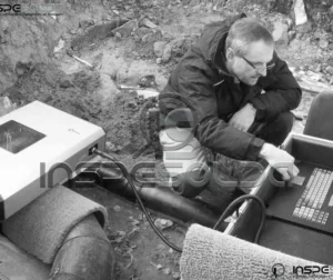 Técnico prepara equipamento para ensaio de radiografia industrial.
